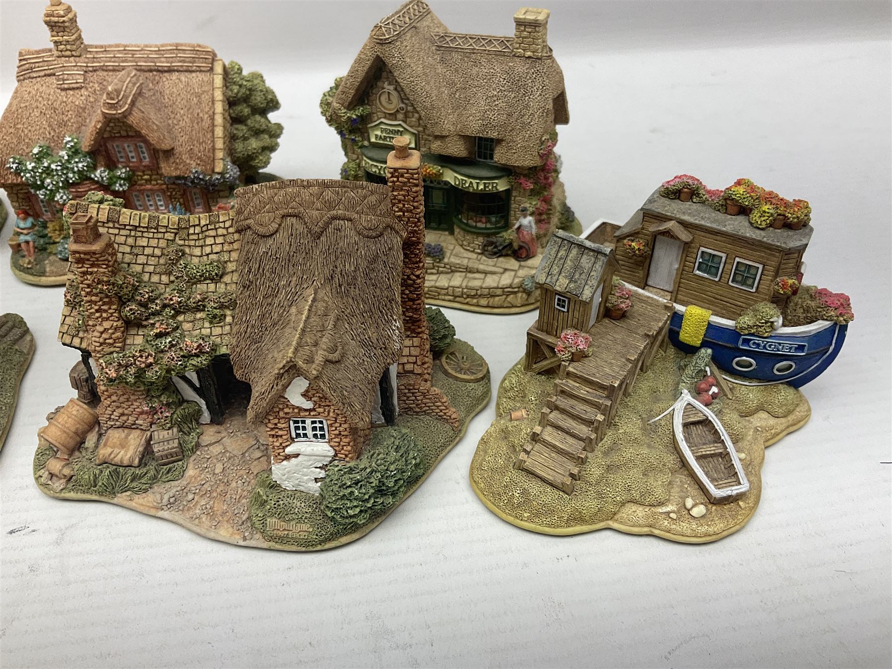 Eighteen Lilliput Lanes, including The Penny Farthing, The Pigsty, Borrowdale School, Fairy Cake Tearoom, An Apple a Day,Ladybird Cottage etc, all with original boxes 