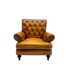 Chesterfield design armchair, upholstered in buttoned tan leather with studwork, on turned feet