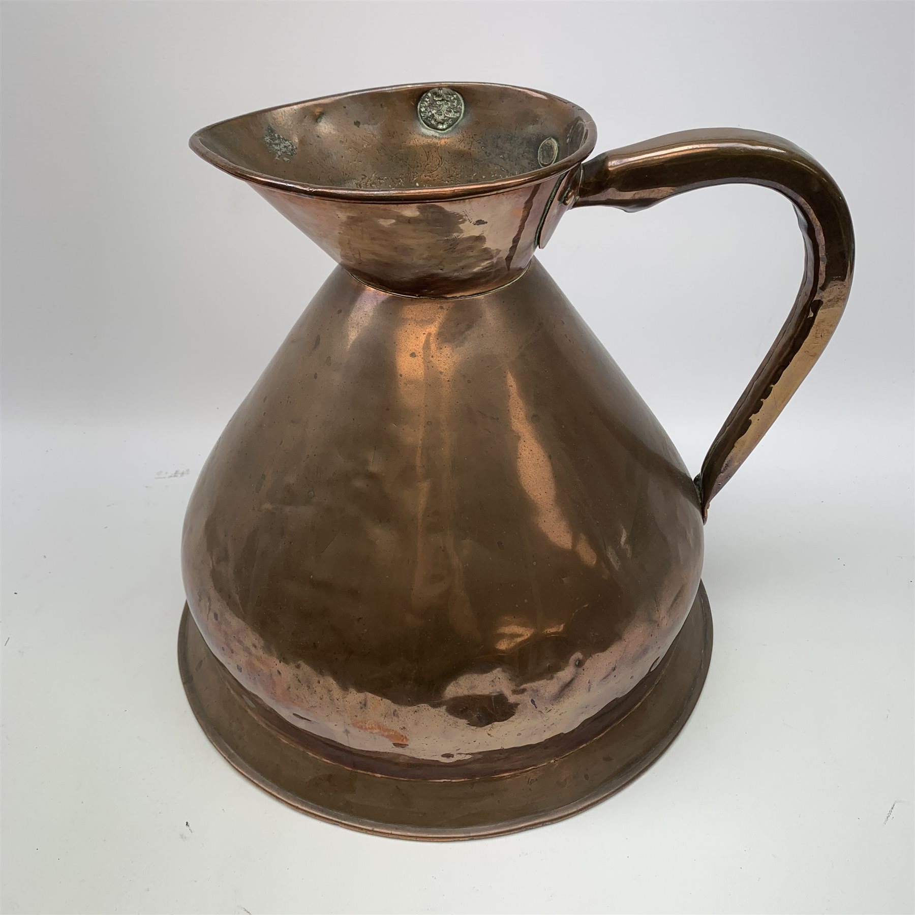 A large 19th century Copper measuring jug, marked 2 Gallon, with lead ...