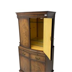 Georgian design mahogany cocktail cabinet, fitted with cupboard enclosing mirror back and single glass shelf, over brushing slide with mirrored plate and two cupboard doors, flanked by fluted uprights