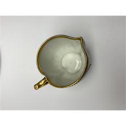 Vienna cabinet cup and saucer, the pedestal cup with funnel bowl decorated with a frieze of classical figures against a textured gilt background, and dark blue ground heightened with gilt, the saucer with raised centre and conforming dark blue gilt detailed ground, cup H10.5cm, saucer D15cm, together with a small Vienna jug of heart shaped form decorated with two circular panels of cupids, H5cm, each with blue 'beehive' mark beneath 