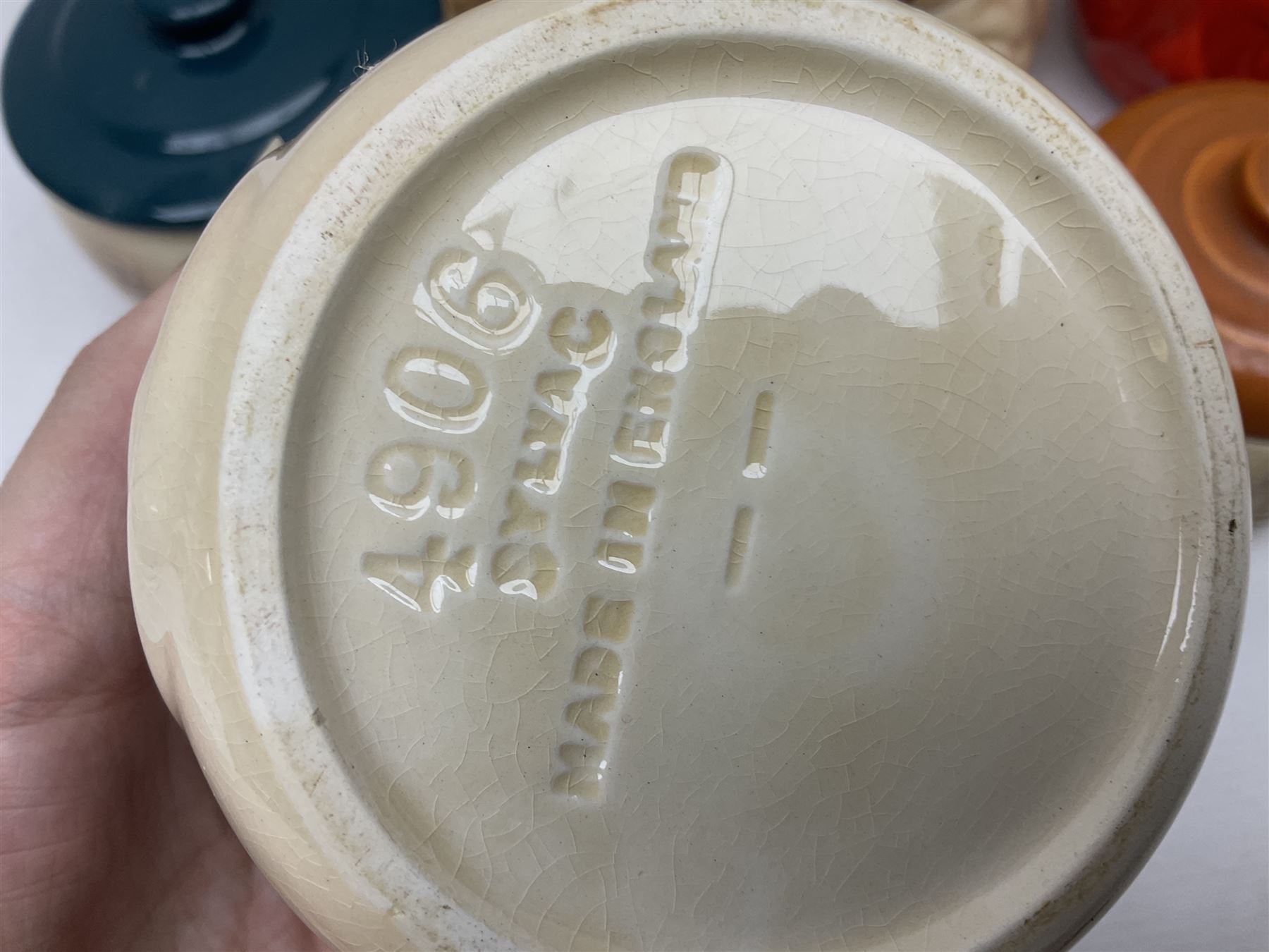 Collection of mostly Sylvac kitchen storage jar face pots, including piccalilli, chutney, tomato and bread sauce, tallest H15.5cm