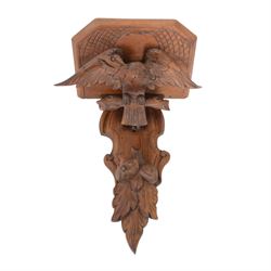 Edwardian oak clock bracket, carved with an eagle support over fruiting foliage, H37cm