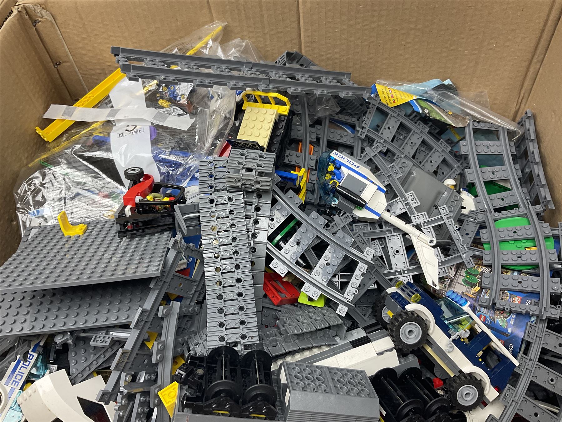 Very large collection of Lego, predominantly loose but some part constructed models, including Lego City, Lego Technic, Chima, Arctic 5, train set, mobile crane etc; together with numerous instruction booklets and some empty boxes; contained in two large cardboard boxes with gross weight of over 24kgs