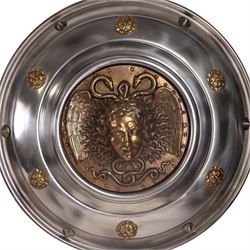 Three wall hanging shields the central panel decorated in relief with Medusa, D56cm 