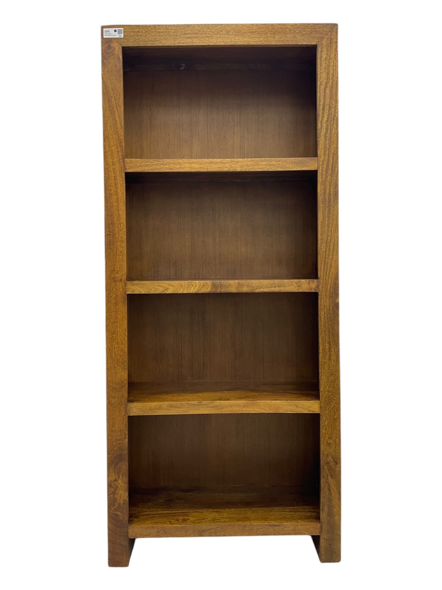 Contemporary Dakota mango wood open bookcase, rectangular form with four fixed open shelves, raised on stile supports