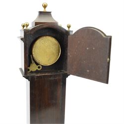 Early 20th century - mahogany cased 8-day miniature longcase clock with a matching wall mounted bracket,  break arch hood with ball finials and recessed quarter pilasters, conforming trunk with a long door and break arch top on a decorative plinth with a raised panel and stepped base, circular dial with Roman numerals and spade hands within a glazed bezel, French insert timepiece movement with a cylinder platform escapement, wound and set from the rear. With key.