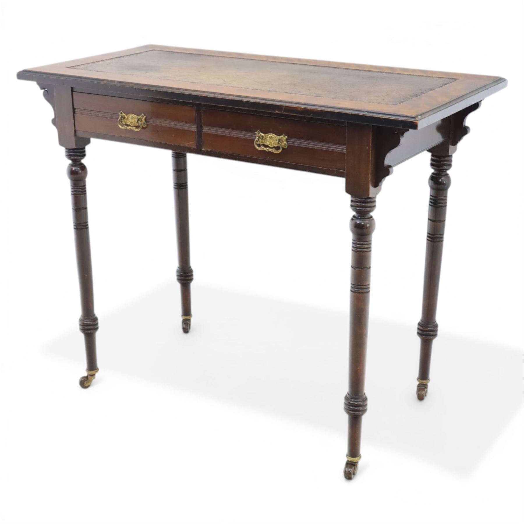 Edwardian mahogany writing table, tooled leather top over two frieze drawers, on turned supports terminating in castors