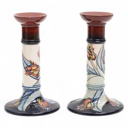 Pair of Moorcroft candlesticks, decorated in the Red Tulip pattern by Sally Tuffin, impressed and painted marks to bases, H21cm (2)