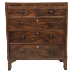 Early 19th century mahogany chest, straight front with canted corners, featuring inlaid detail above two short and three long drawers with flame veneered facias