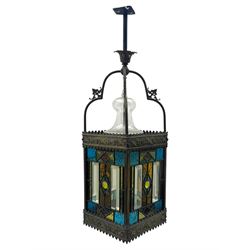 20th century Gothic design stained glass and brass hall lantern, with ornately decorated frieze and apron, with geometric coloured glass panels and eight rectangular bevelled glass panels, with bell shade, wired for electricity 