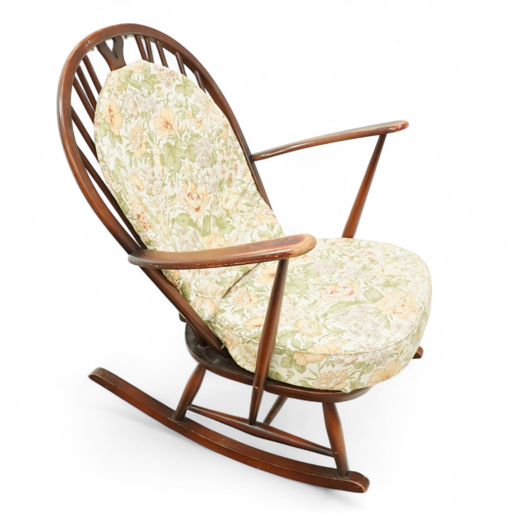 Ercol - Mid-20th century ‘Fleur-de-Lis’ rocking chair, elm and beech frame with curved arms, pierced back crest and stick supports, floral upholstered seat and back cushions, on curved rockers