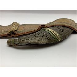 Late 19th century Yemeni Tuza jambiya as worn by religious elite, the 20.5cm curving blade with raised medial ridge, the horn hilt with pique style studwork, in a leather wrapped wooden scabbard with pierced metal mount and leather belt applied with embroidered 'gold' and 'silver' thread work panel; dagger L36cm overall, belt L84cm