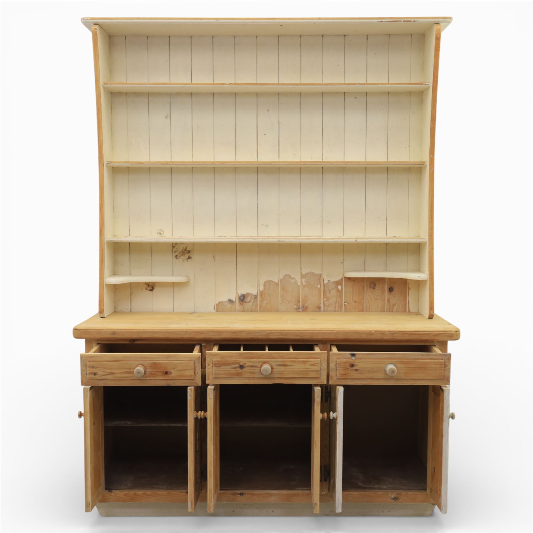 Late 20th century pine and white painted dresser, the upper section with three shelves and boarded back, upon a base with three drawers with knob handles and three panelled cupboard doors, on a raised sled base