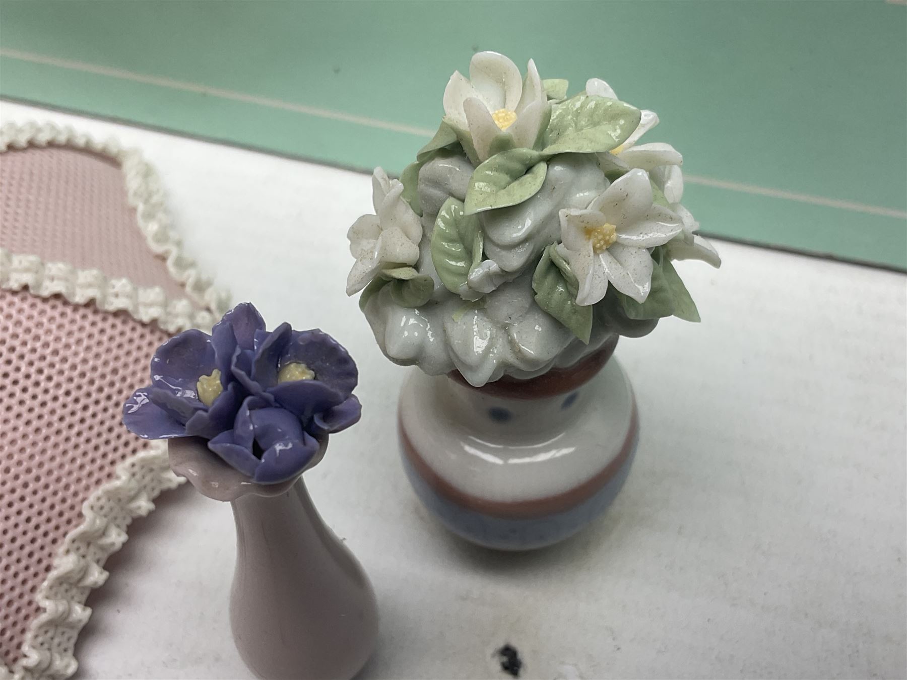 Seven Lladro flowers, comprising Japanese Camelia on base no 5181, Yellow Begonia on base no 5186, Miniature Begonia on base no 5188, Chrysanthemum on base no 5189, California Poppy no 5190.B, Miniature Begonia 5188.B and White Carnation no 5184.B, together with Lladro Spanish Joining pack with 17616 Winter Bell, Additional Lladro parasols and flowers etc 