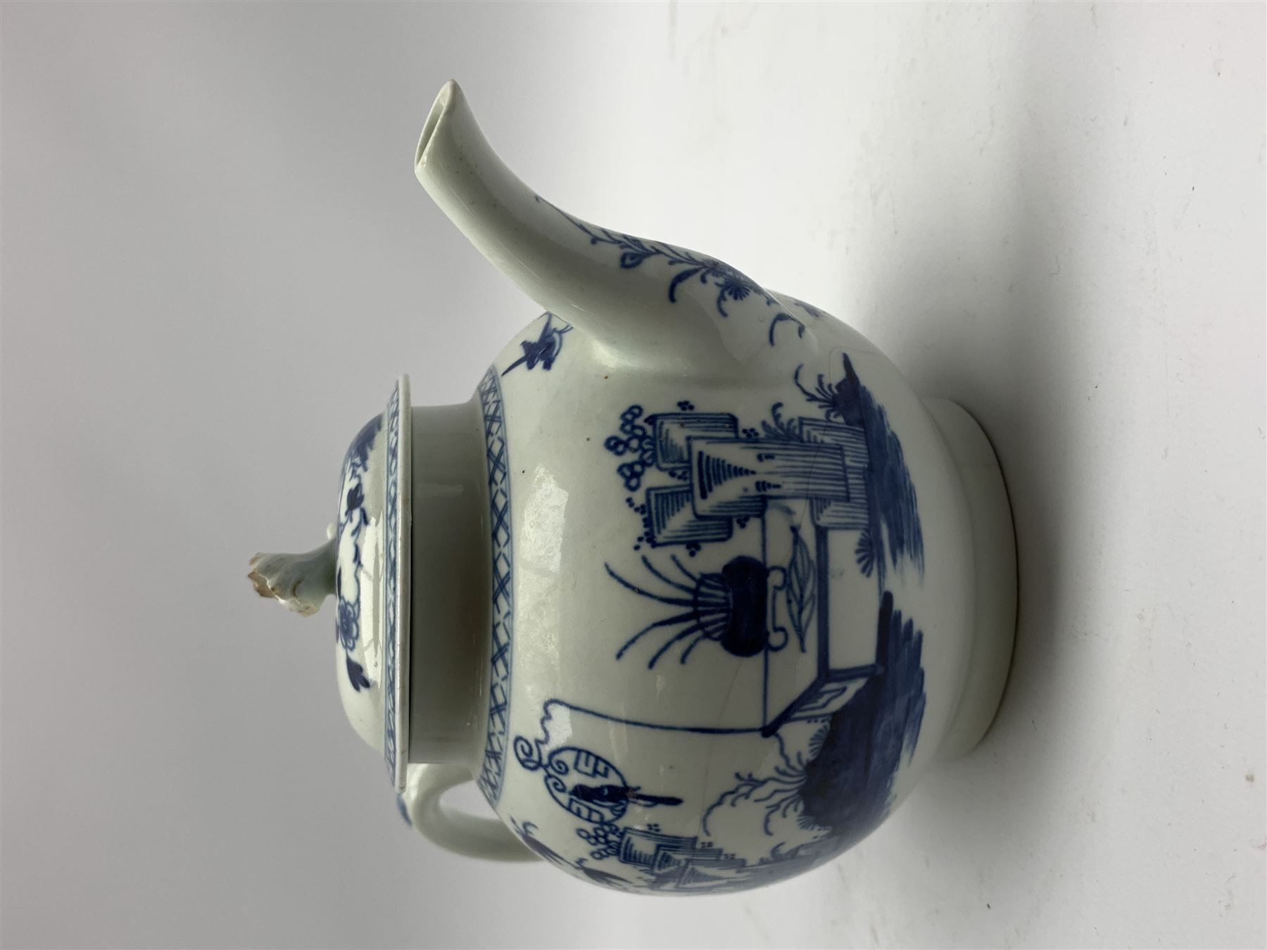 18th Century Worcester teapot, circa 1765-70, decorated in the Bird in the ring pattern, the cover with bud finial, with crescent mark beneath, H13cm, together with a Worcester coffee cup decorated in the same pattern, with crescent mark beneath, H6.5cm
