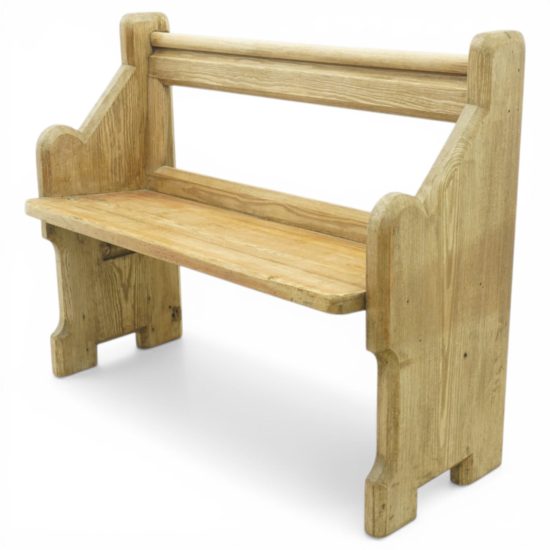 19th century pine pew of small proportions, open rectangular back with panelled frame, rounded top rail and plank seat, shaped slab ends with chamfered detail