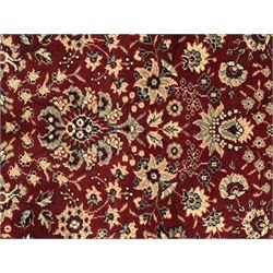 Royal Kashmir worsted wool modern Persian design area rug, with crimson field and stylised rosette patterning throughout, surrounded by wide multi-band border incorporating cartouche and lotus flower motifs