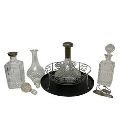 Four glass decanters with stoppers, and three decanter labels 