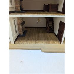 1:24 scale stone effect three-storey cottage dolls house, with green arched door and lattice effect windows, decorated to the interior with wooden floors, wired lighting and fire places, H45cm, W57cm, D26cm