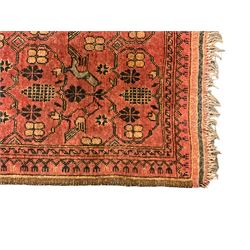 Old Afghan red ground rug, decorated with repeating bird motifs, the guarded border with candelabra pattern (150cm x 104cm); and antique Afghan burnt orange ground rug, field decorated with octagonal lozenges, repeating geometric border (134cm x 95cm) (2)