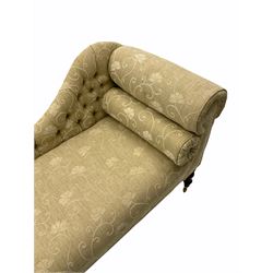 Victorian style chaise longue, upholstered in pale ground fabric decorated with raised foliate pattern design, with bolster cushion, on turned supports with castors