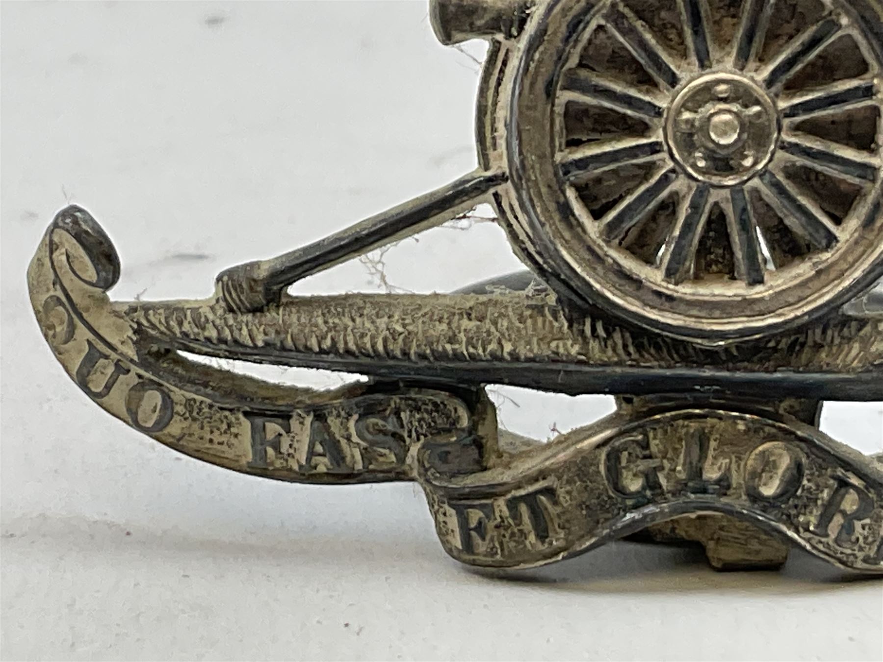 Trench Art - three WW2 brass shell case ashtrays, one mounted with Royal Artillery cap badge and button and one mounted with RA button; together with a pair of place name holders each formed from a Royal Artillery cap badge (5)