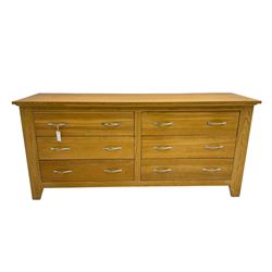 Contemporary wide oak straight-front chest, fitted with a bank of six drawers with chrome handles, on tapered feet