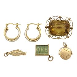 Early 20th century gold citrine brooch, pair of gold hoop earrings and three gold charms including fish, money box and 'Good luck' spinner, all 9ct