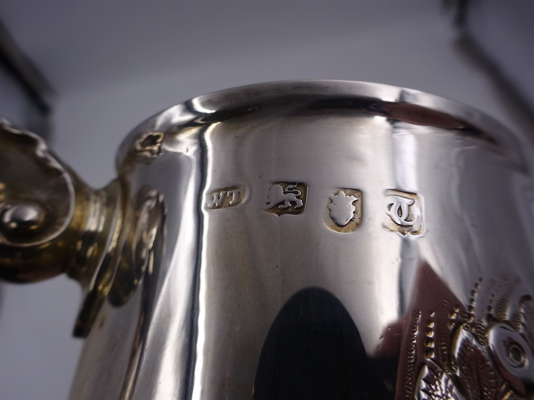 George III silver tankard, of slightly tapering cylindrical from, with chased and repousse crown above a monogrammed cartouche and floral, foliate and C scroll decoration, with acanthus capped C scroll handle, hallmarked WT, possibly William Turton, London 1774, H11.5cm