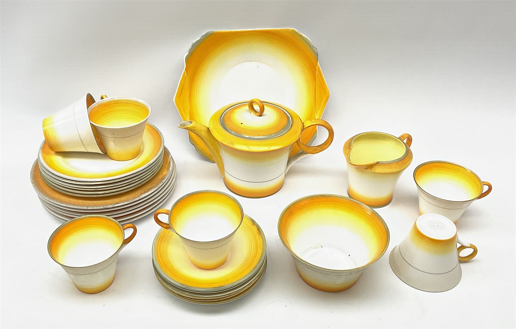 A Shelley Art Deco tea service, decorated in pattern no W12405, with bands of grey, orange and yellow, comprising teapot, open sucrier, milk jug, cake plate, six teacups, six saucers, six side plates, and six dessert plates. 