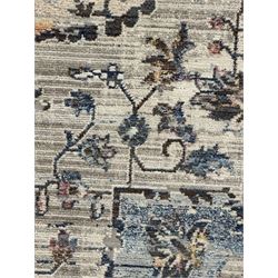 Contemporary Dunelm Soraya Persian design rug, blue and beige ground with faded floral and vine motifs, central medallion and trailing foliate patterns, bordered by a distressed design with stylised floral motifs