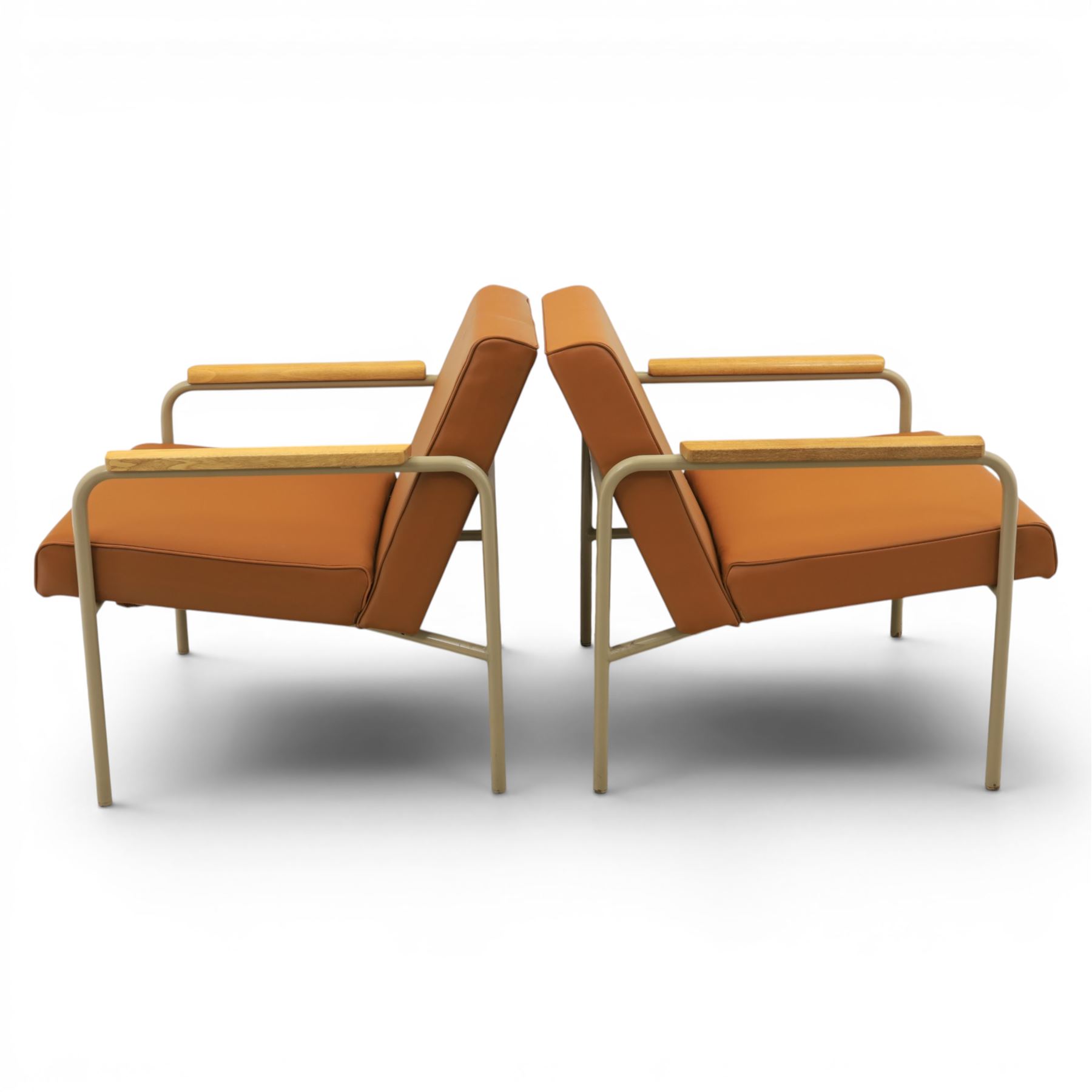Pair of mid-20th century painted wrought metal easy armchairs with tan leather upholstery and teak armrests