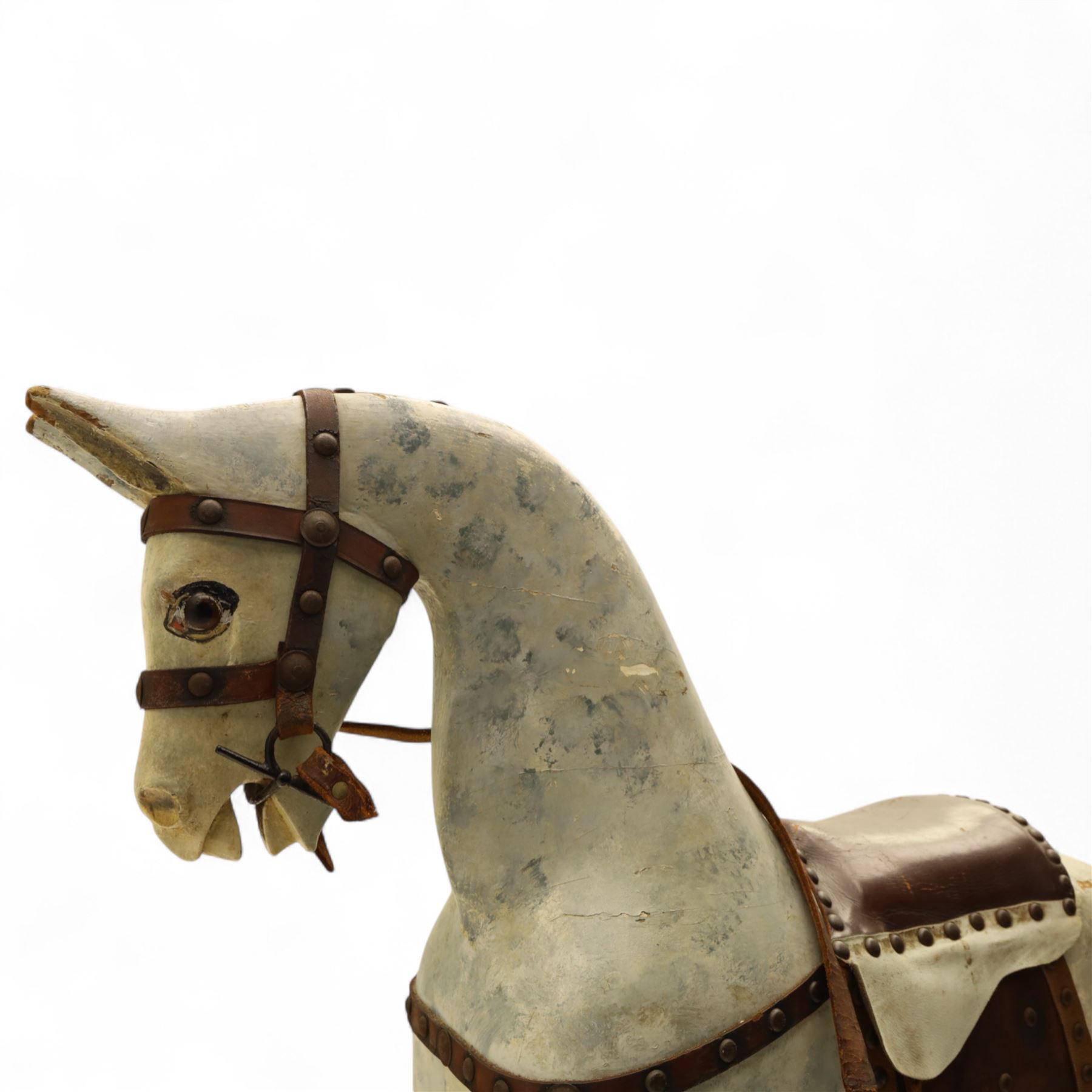 20th century carved and painted rocking horse, with original dappled paint finish, studded leather saddle and reins, on later red and black swing frame