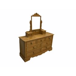 Pine dressing chest, raised rectangular swing mirror fitted with two drawers, the chest fitted with seven drawers