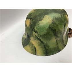 Fully restored German steel helmet, the camouflage painted exterior with two decals and replacement leather liner