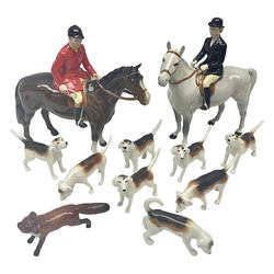 Beswick hunting group, comprising huntswoman on grey horse no 1730, huntsman on brown horse no 1501, fox figure no 1440 and eight fox hounds, all with printed marks beneath (11)
