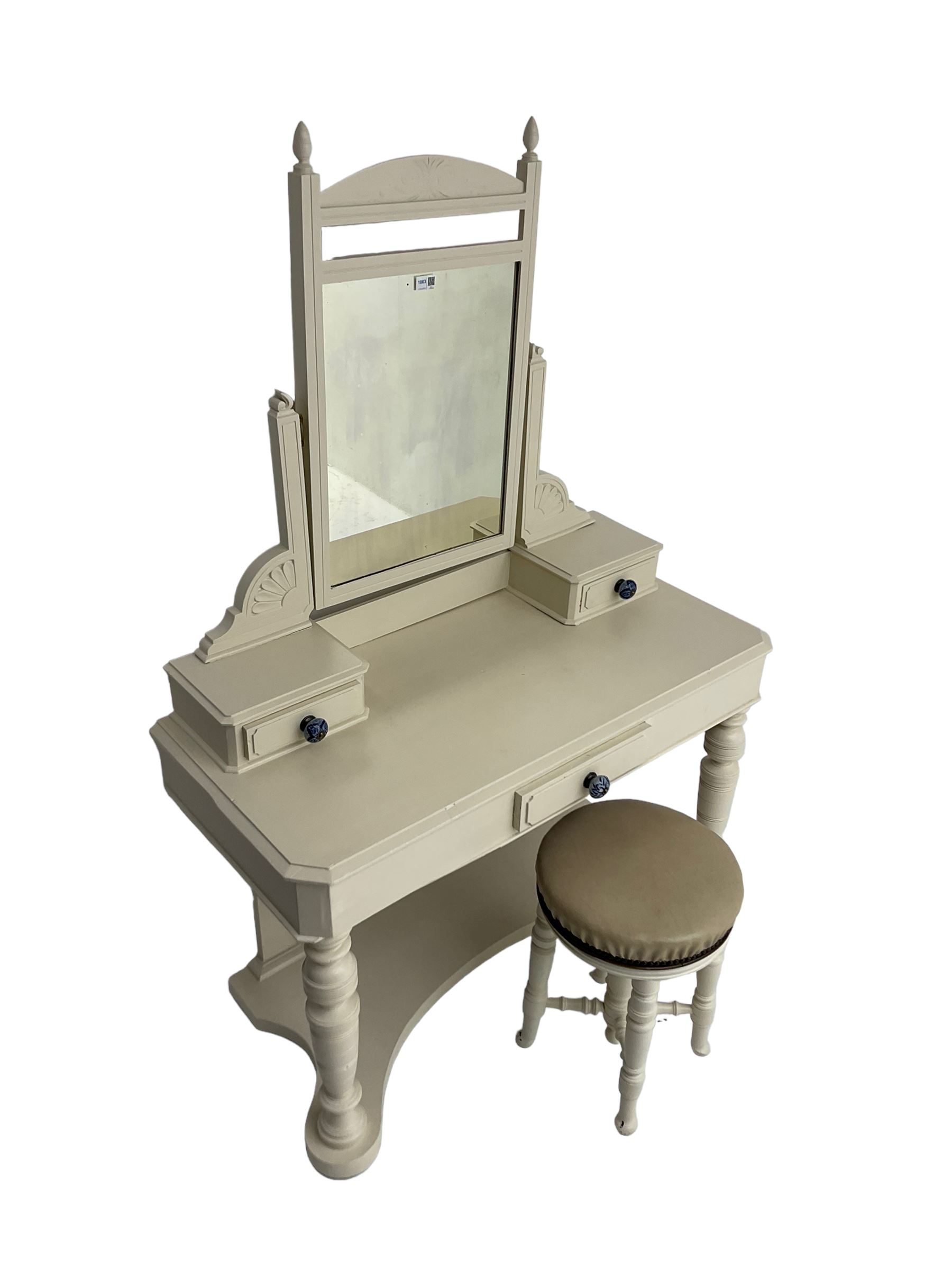 Edwardian cream painted dressing table, fitted with rectangular swing mirror over two trinket drawers with ceramic handles, rectangular top with frieze drawer, raised on turned front supports; with circular stool, leather seat over four turned supports