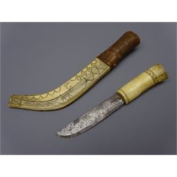  Early 20th century Scandinavian knife, 12.5cm single edge blade with bone handle, in two piece curved bone sheath with leather collar, scrimshaw decorated with reindeer and repeating strapwork, L29.5cm   