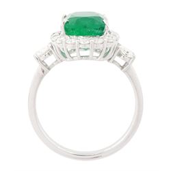 18ct white gold emerald and diamond cluster ring, single cushion cut emerald of approx 2.45 carat, surrounded by eighteen round brilliant cut diamonds, with a single oval cut diamond set either side, stamped, total diamond weight approx 1.05 carat