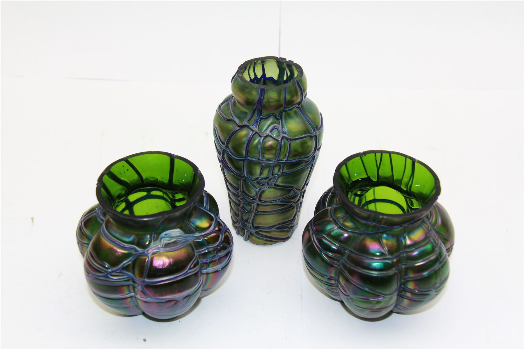 Three Austrian Art Nouveau Kralik iridescent glass vases, to include two of squat baluster form and a taller example, all green with threaded vein decoration to body, tallest H13.5cm