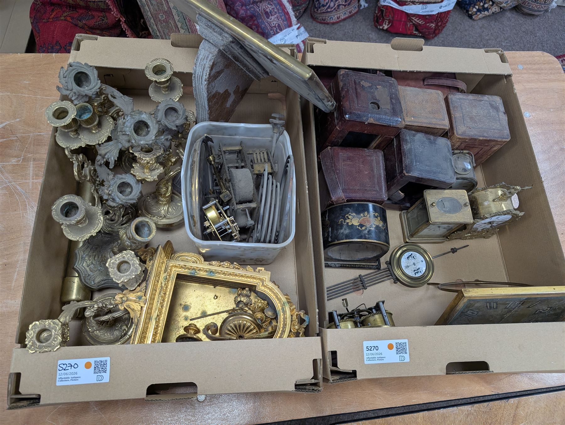 Collection of leather carriage clock cases, brass mantle clocks and parts, brass candlesticks etc, in two boxes