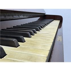 Waddington - Edwardian mahogany upright piano, rectangular top with panelled front, rounded key cover, makers name on fallboard, raised on bracket supports with castors