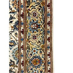Fine Persian Kashan rug, ivory ground and decorated with interlacing branch and stylised plant motifs, scrolling guarded border decorated with small flower heads