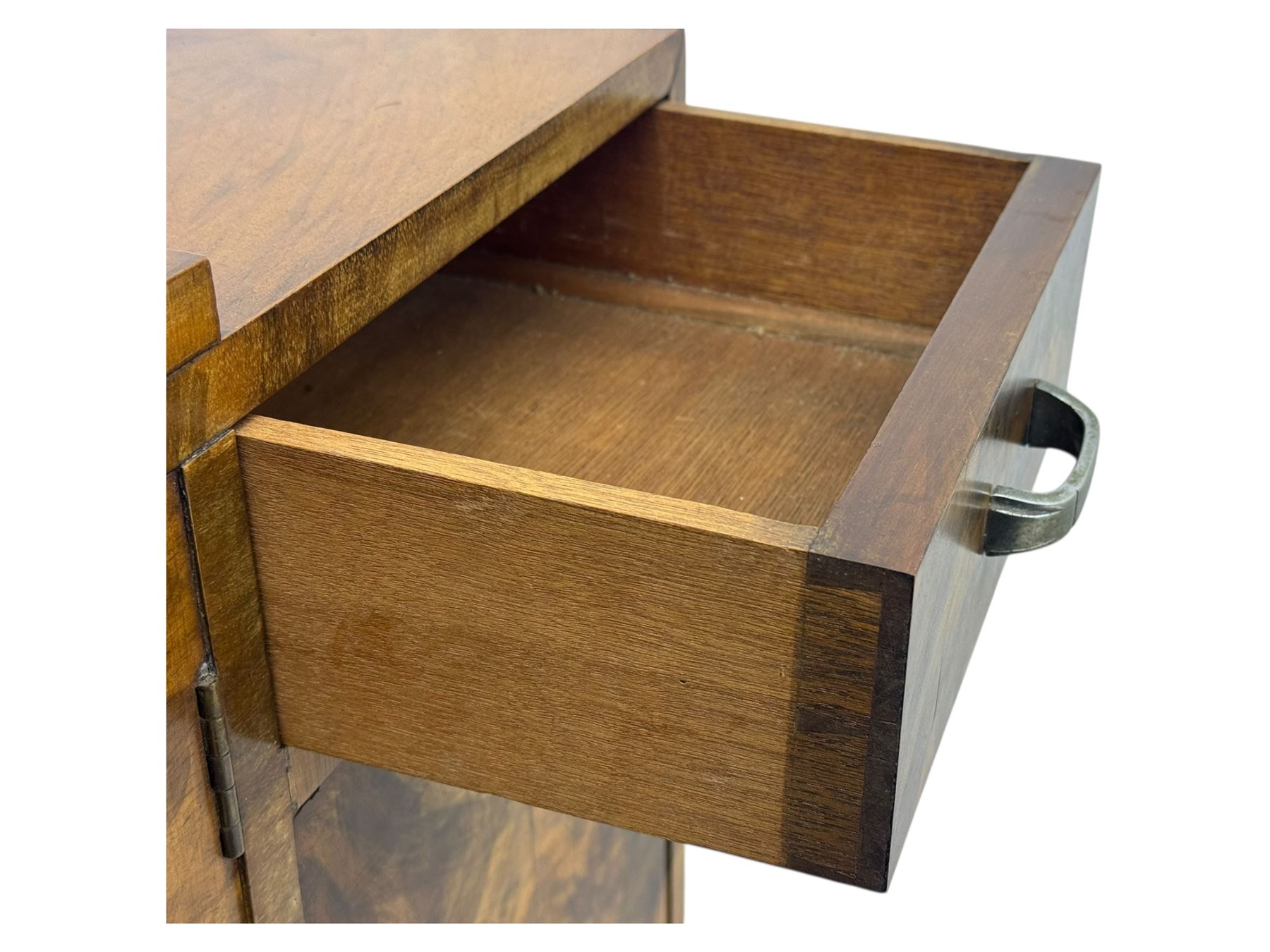 Art Deco burr walnut drinks cabinet, geometric central glazed astragal door enclosing two fixed shelves, flanked by symmetrical bookmatched veneered cupboards with drawers above 