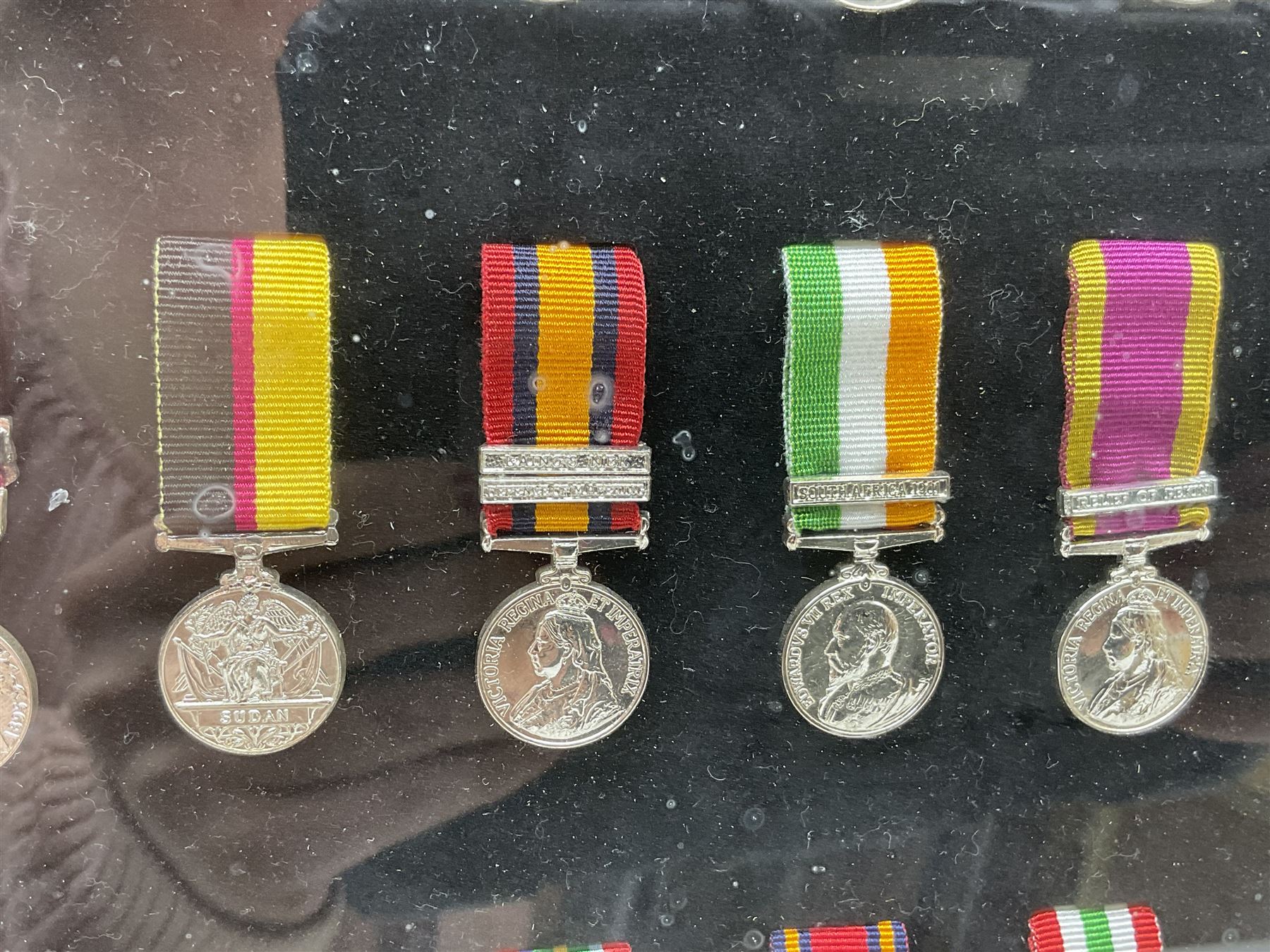 Limited edition large framed display board with sixty half-size copies of British Gallantry and Campaign Medals produced by Danbury Mint; all with ribbons and associated booklet