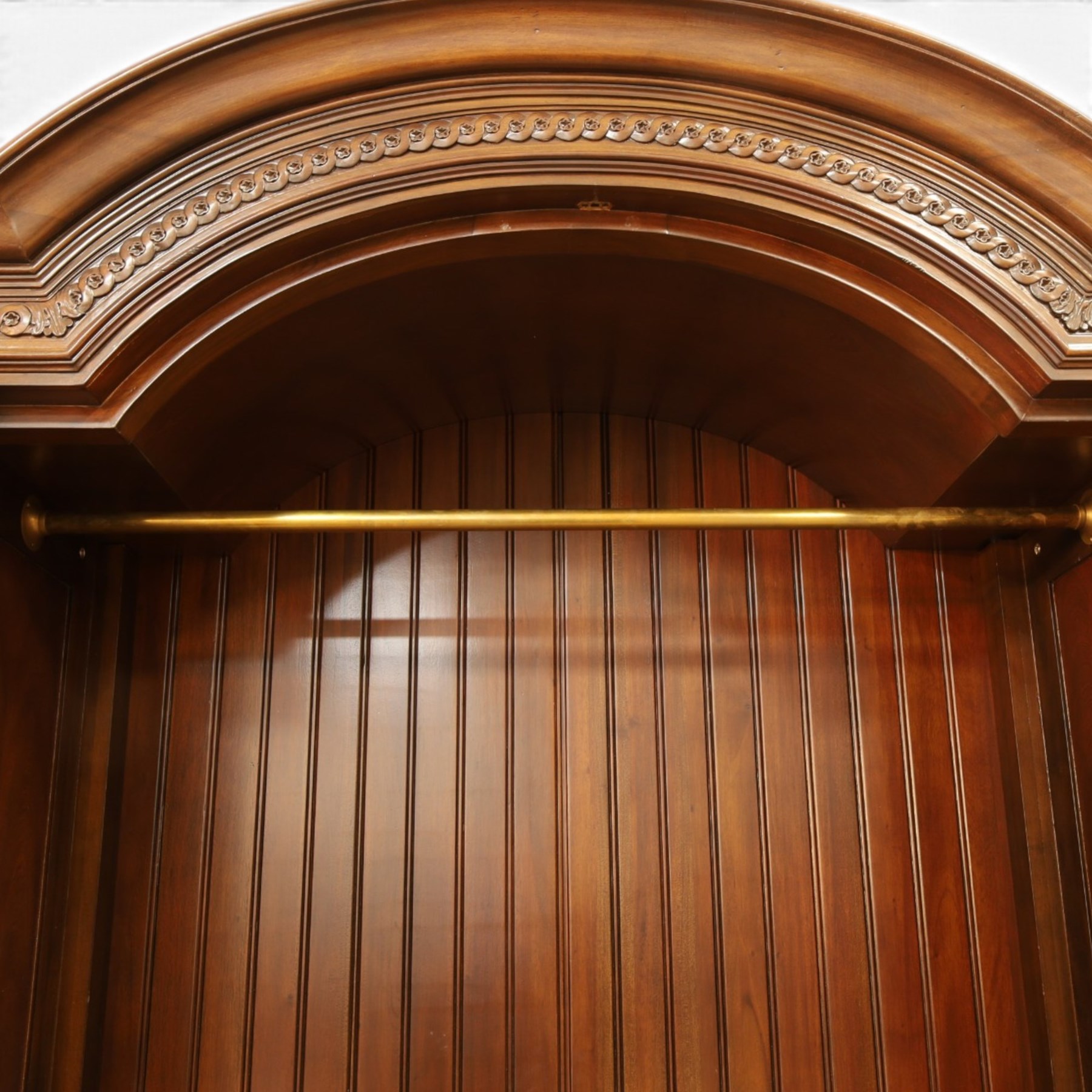 And So To Bed - French design ‘Eclectic’ double wardrobe in dark finish, arched moulded cornice with carved foliate band and turned finials, two mirrored doors enclosing a hanging rail, flanked by turned columns with foliate decoration, single fluted drawer below, on turned tapering feet