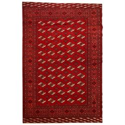 Turkmen hand-knotted carpet, deep crimson ground field, with an all-over lattice of repeat...