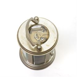 20th century-Silver plated 8-day timepiece carriage clock in an oval case, enamel dial with Roman numerals, minute track and steel moon hands, with an oval viewing class to the lever platform escapement. With key.