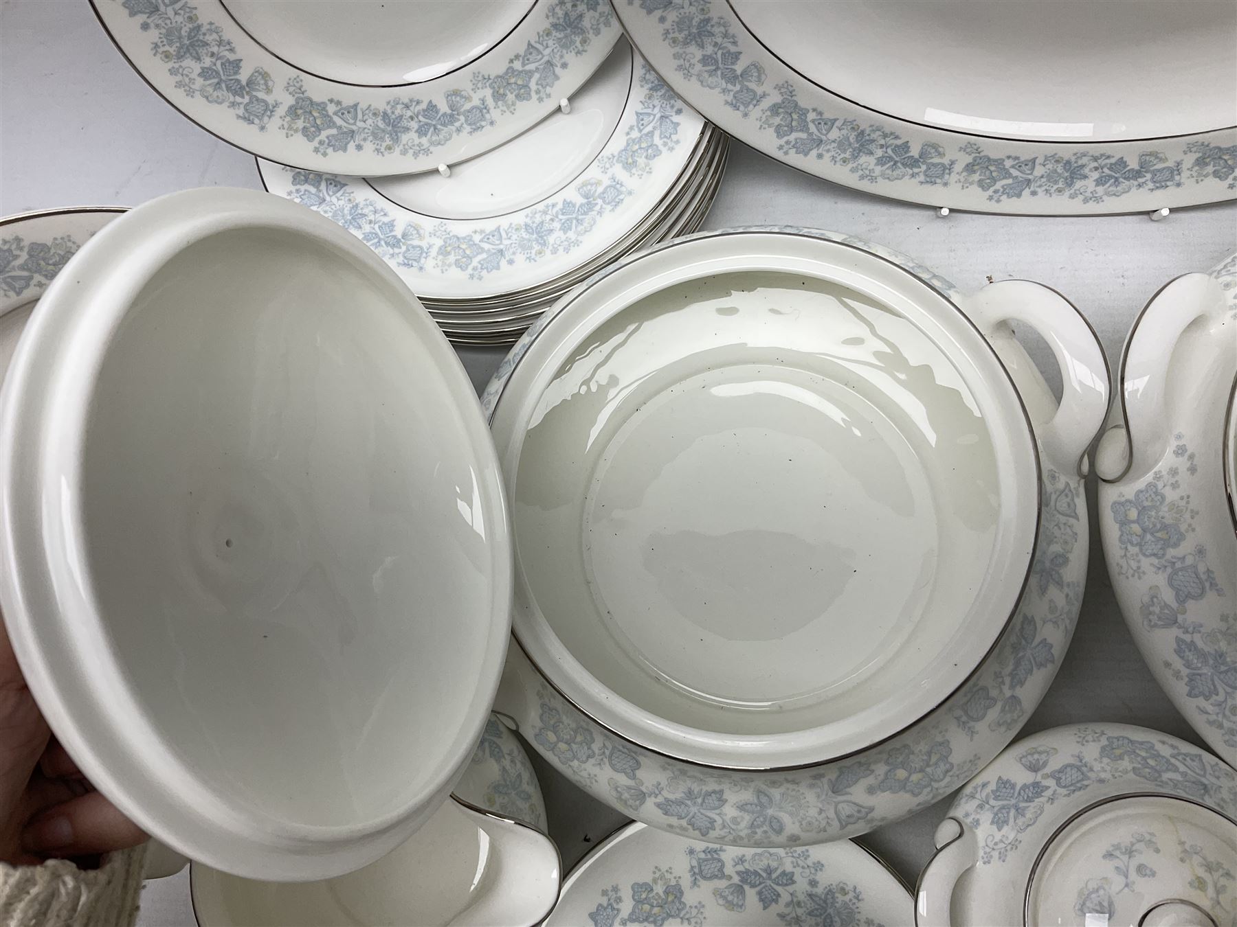 Royal Doulton tea and dinner wares in the Meadow Mist pattern, no H5007, comprising seven dinner plates, eight side plates, two lidded tureens, two jugs, lidded sucrier, oval serving dish, six teacups, seven saucers, seven tea plates and large saucer
